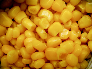 Yellow canned corn in a tin can on a white background. Background.