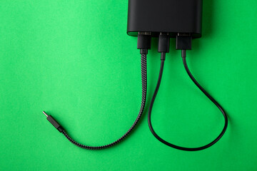 Black Power Bank with adapter for charging mobile devices. Power Bank close-up.