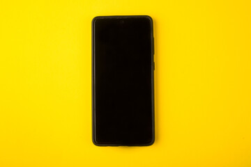 Smartphone on a yellow background. Smartphone close up