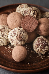 Fototapeta na wymiar Chocolate vegan truffles on a plate. Homemade sweets.