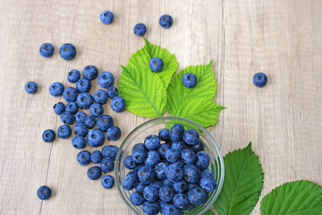 Fresh blueberries on wooden background, close up of berries juicy ripe fruit