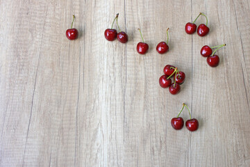 Fresh cherries on wooden background, close up of juicy ripe fruit