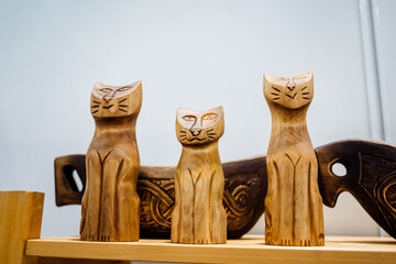 Cats are a derovo craft. handmade from wood. Cut the table toy. the image of a kitten. wood carving