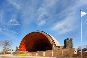 Hatch Shell on Charles River Esplanade on a sunny spring day.  the shell is an open-air half-dome for concerts and entertainment.