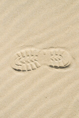 Fototapeta na wymiar View of a shoe footprint in the sand