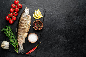 baked trout fish on a stone background with copy space for your text