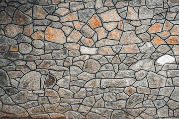 Texture of a stone. Old stone wall texture background. Grey stone wall as a background or texture. Stone wall of natural stones in different sizes. Side covering with natural stones.