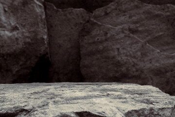 A Split Tone Image of a Dry Rock Shelf, Showing Middle Focus to a Rough Textured Stage of a Blue and Grey Mineral. 