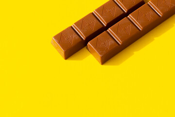 small chocolate bars on a yellow background