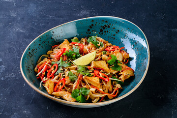 Chicken pad Thai dish of stir fried rice noodles