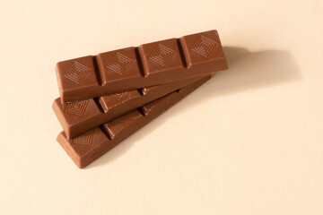 small chocolate bars on a pastel background