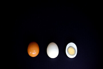 three eggs on black background