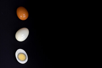 three eggs on black background