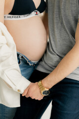 belly of a pregnant woman and her man