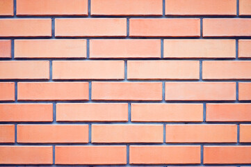 Obraz premium The wall, made of old red bricks, darkened by old age. Ancient vintage brick wall background. Brick wall backdrop