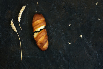 Top view of a loaf of bread. A loaf of bread is broken into two halves. Flat lay with copy space. Donation concept to hungry people