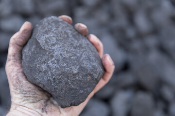 a lump of coal in hand
