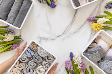 Stylish composition storage underwear organization Marie Kondo's method decorated by natural flowers