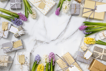 Top view trendy composition with festive wrapped gift boxes ribbon bow decorated by bloom flowers
