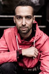 Close up portrait of young smiling handsome in red anorak
