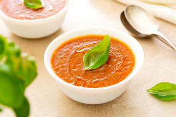 Gazpacho tomato soup, bowl of vegetable soup with basil leaves