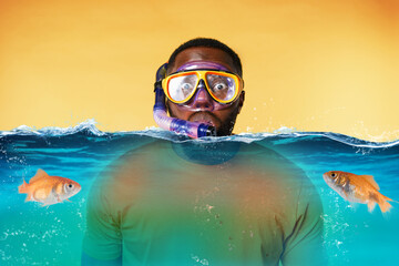Man with snorkeling mask is scared to go underwater. yellow background