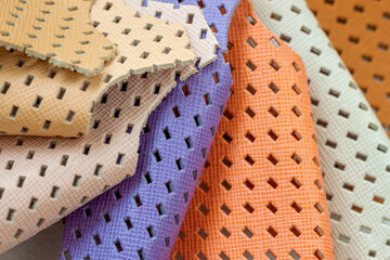 Set of colorful samples of fashion matte perforated genuine leather.