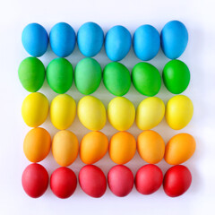 Easter eggs on white background, rainbow colors, top view