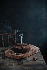 Chocolate cake with candles, Chocolate cake with mascarpone on rustic background.