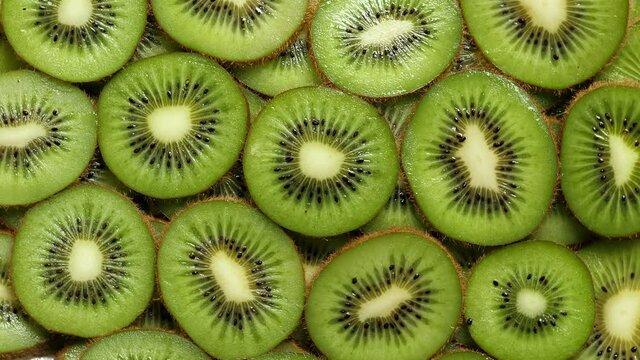 A lot of sliced Kiwi rotating. Ripe Tropical fruits closeup