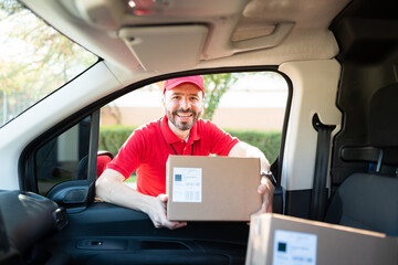 Portrait of an hispanic worker delivering a package