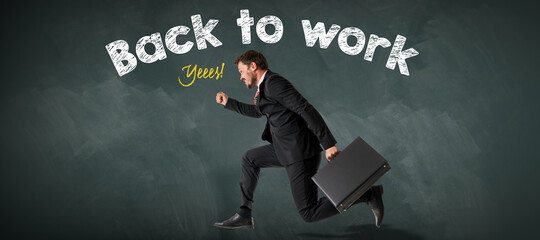 running business in a suit and with a briefcase in front of a blackboard with the message BACK TO WORK, YESSS!