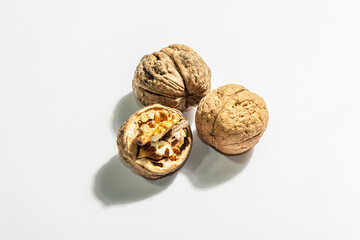 Whole and half walnuts isolated on white background