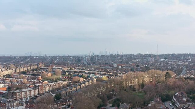 Slider sideways drone shot over suburban north London looking towards city centre