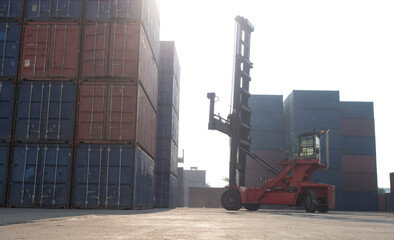 Terminal warehouse mortgage cargo container orange color forklift crane trade engineer technology transportation company factory logistic ecommerce international import export customer.Sky cloud white