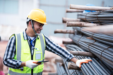 Inspectors are inspecting rebars at a construction site for rebar or reinforcement. - obrazy, fototapety, plakaty