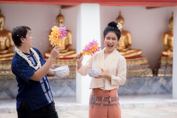 Young Asian youth playing in the water during
