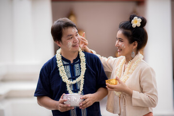 Young Asian youth playing in the water during