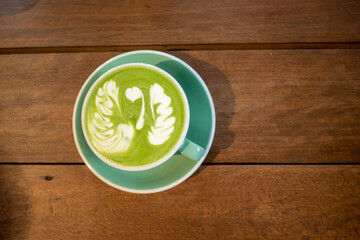 Green tea art pattern on wooden table