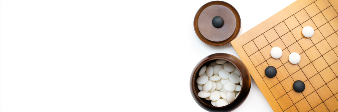 top view of weiqi-baduk-igo board game (This is an adversarial game with the objective of surrounding a larger total area of the board with one's stones than the opponent)