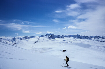 Fototapeta na wymiar A woman ski touring in The Chugach Mountains, Alaska