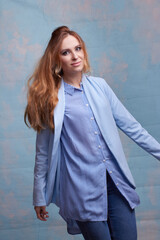 young beautiful Caucasian woman, on a blue background.