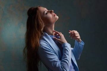 young beautiful Caucasian woman, in a blue suit,