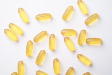 Omega 3 capsules on white background. Fish oil softgels. Supplement food vitamin D capsules. Top view - Image