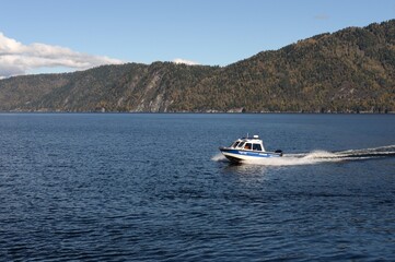 Fototapeta premium The NorthSilver PRO 745 Cabin boat of the transport police is patrolling the waters of Lake Teletskoye. Altai Republic