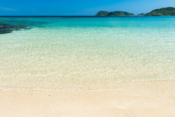 Beautiful white sand beach, crystal clear turquoise water that extends to the horizon, perfect for swimming and relaxing. Iriomote Island.