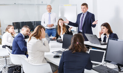 Irritated boss scolding subordinates, pointing out shortcomings and misses in work