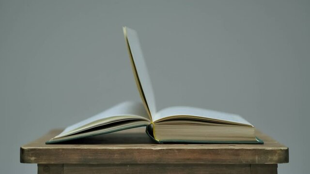 Closeup View Video Of Old Open Paper Book Laying On Chair. Shot On RED EPIC Cinema Camera.