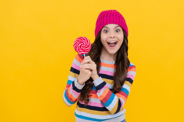 surprised kid girl hold lollipop sweet, copy space, caramel shop