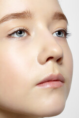 Fototapeta premium Closeup shot of human teenager girl face. Young female with natural face and eyes beauty makeup